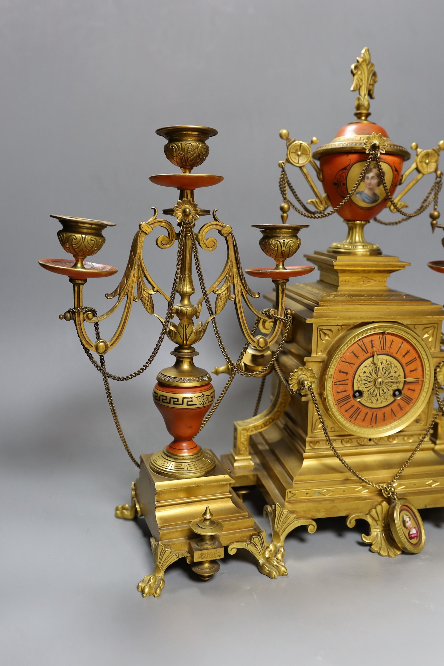 A late 19th century French Etruscan revival ormolu and porcelain mounted three piece clock garniture, 40cm